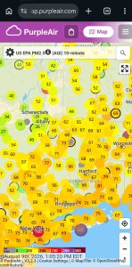 Green AQI symbols with low numbers in a high-pollution zone
